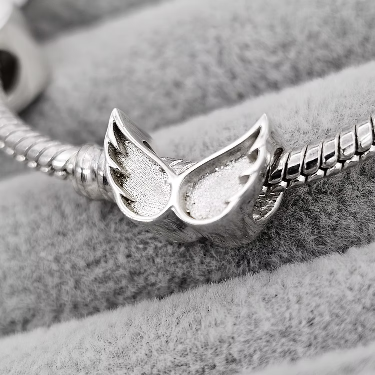 Angel wing charm
